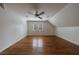 A large bedroom has a ceiling fan, hardwood floors, and natural light at 5004 Haralson Sw Way, Lilburn, GA 30047