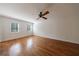 Bright bedroom with hardwood floors, neutral walls, and shuttered windows at 5004 Haralson Sw Way, Lilburn, GA 30047