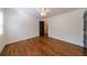 Bright bedroom features hardwood floors, ceiling fan, and a neutral color palette at 5004 Haralson Sw Way, Lilburn, GA 30047