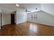 Upstairs bedroom boasts hardwood floors, natural light, and a ceiling fan at 5004 Haralson Sw Way, Lilburn, GA 30047