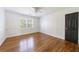 Bedroom with a ceiling fan, a large window, and hardwood floors at 5004 Haralson Sw Way, Lilburn, GA 30047