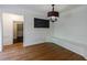 Bright dining area featuring hardwood floors, built-in bench seating, and a modern chandelier at 5004 Haralson Sw Way, Lilburn, GA 30047