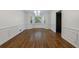 Dining room featuring hardwood floors, wainscoting, and bay windows at 5004 Haralson Sw Way, Lilburn, GA 30047
