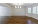 Well-lit dining room with a bay window, hardwood floors, and classic trim at 5004 Haralson Sw Way, Lilburn, GA 30047