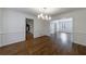 Formal dining room with hardwood floors, wainscoting, and modern lighting at 5004 Haralson Sw Way, Lilburn, GA 30047