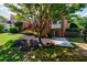 Backyard featuring lush landscaping, a brick facade, and a covered patio, perfect for outdoor entertaining at 5004 Haralson Sw Way, Lilburn, GA 30047