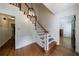 Bright foyer with hardwood floors, staircase, and decorative lighting at 5004 Haralson Sw Way, Lilburn, GA 30047