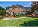 Inviting two-story brick home with lush lawn and colorful landscaping at 5004 Haralson Sw Way, Lilburn, GA 30047