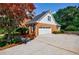 Side view of property with a garage and beautiful foliage at 5004 Haralson Sw Way, Lilburn, GA 30047