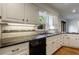 This kitchen has updated cabinets, granite countertops, stainless steel appliances, and backyard view at 5004 Haralson Sw Way, Lilburn, GA 30047