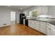 The kitchen features black appliances, granite countertops, modern cabinets, and a convenient breakfast bar at 5004 Haralson Sw Way, Lilburn, GA 30047