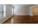Spacious living room with hardwood floors and large windows with plantation shutters at 5004 Haralson Sw Way, Lilburn, GA 30047