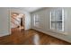 Living room featuring hardwood floors, crown molding, and plantation shutters at 5004 Haralson Sw Way, Lilburn, GA 30047