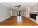 Spacious living room with hardwood floors, fireplace, built-in shelves, and french doors to the backyard at 5004 Haralson Sw Way, Lilburn, GA 30047