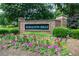 Haralson Hills brick community entrance sign surrounded by landscaping and colorful flowers at 5004 Haralson Sw Way, Lilburn, GA 30047