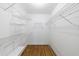 A walk-in closet offers ample storage with extensive wire shelving and wood-look flooring at 5004 Haralson Sw Way, Lilburn, GA 30047