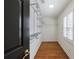 Bright walk-in closet features hardwood floors, adjustable shelving, and natural light from a window at 5004 Haralson Sw Way, Lilburn, GA 30047