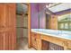 Bathroom featuring wood cabinetry and open access to closet at 5419 Ahyoka Dr, Morrow, GA 30260