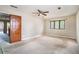 Bedroom with ceiling fan, window, and access to the hallway at 5419 Ahyoka Dr, Morrow, GA 30260