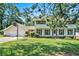 Two-story home with a well-manicured lawn, black shutters, a basketball hoop, and an attached two-car garage at 5419 Ahyoka Dr, Morrow, GA 30260