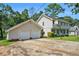 Exterior showcasing a two-car garage and basketball hoop at 5419 Ahyoka Dr, Morrow, GA 30260