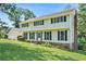 Two-story home with black shutters and a brick chimney and a simple, landscaped front yard at 5419 Ahyoka Dr, Morrow, GA 30260