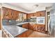 Kitchen with dark wood cabinets, dark countertops, stainless steel refrigerator and brick floors at 5419 Ahyoka Dr, Morrow, GA 30260