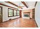 Sunlit living room with hardwood floors, wood-trimmed windows, built-in shelves, and a stone fireplace at 5419 Ahyoka Dr, Morrow, GA 30260