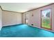 Bright living room with large windows and plush blue carpeting at 5419 Ahyoka Dr, Morrow, GA 30260