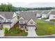 Aerial shot showcasing a beautiful brick home with a manicured front lawn and mature trees in a tranquil setting at 1459 Bennett Creek Ovlk, Suwanee, GA 30024