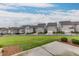 Picture of a large backyard with a green lawn, enclosed by a sleek black fence with neighboring homes in the background at 1459 Bennett Creek Ovlk, Suwanee, GA 30024