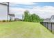 Expansive backyard with lush green lawn and a sleek black fence for privacy at 1459 Bennett Creek Ovlk, Suwanee, GA 30024