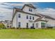 Large, manicured backyard featuring a modern white home and lush green lawn at 1459 Bennett Creek Ovlk, Suwanee, GA 30024