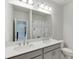 Modern bathroom featuring double vanity with white countertop and gray cabinetry at 1459 Bennett Creek Ovlk, Suwanee, GA 30024