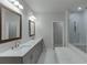 Bright bathroom with dual sinks, a marble countertop, modern fixtures, and walk in shower that provide a luxurious feel at 1459 Bennett Creek Ovlk, Suwanee, GA 30024