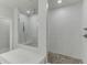 Bathroom features a glass-enclosed shower with a mosaic floor and tiled walls, complemented by a sleek design at 1459 Bennett Creek Ovlk, Suwanee, GA 30024