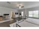 Spacious bedroom with a ceiling fan, computer desk, and large windows offering plenty of natural light at 1459 Bennett Creek Ovlk, Suwanee, GA 30024
