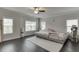 Bright bedroom with a ceiling fan, large windows, and dark hardwood floors, providing a cozy and inviting space at 1459 Bennett Creek Ovlk, Suwanee, GA 30024