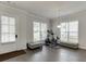 Bonus room with hardwood floors, two windows, and space for exercise equipment at 1459 Bennett Creek Ovlk, Suwanee, GA 30024