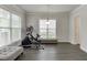 A bright bonus room with hardwood floors, two windows and space for exercise equipment at 1459 Bennett Creek Ovlk, Suwanee, GA 30024