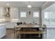 Dining area adjacent to the kitchen, featuring modern lighting and a large window with natural light at 1459 Bennett Creek Ovlk, Suwanee, GA 30024