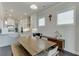 Dining table setup features natural light, and views to the kitchen with white cabinets and steel range hood at 1459 Bennett Creek Ovlk, Suwanee, GA 30024