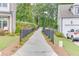 Long driveway leading up to the house and garage, complemented by landscaped edges, enhancing curb appeal at 1459 Bennett Creek Ovlk, Suwanee, GA 30024
