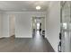 An open-concept home entrance showing the foyer with hardwood floors, crown molding, and glass front door at 1459 Bennett Creek Ovlk, Suwanee, GA 30024