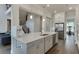 Spacious kitchen with a large island, stainless steel appliances, and a view of the staircase at 1459 Bennett Creek Ovlk, Suwanee, GA 30024