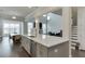 Beautiful open-concept kitchen with white countertops and stainless steel appliances, flowing into the dining and living areas at 1459 Bennett Creek Ovlk, Suwanee, GA 30024