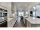 Modern kitchen featuring stainless steel appliances, subway tile backsplash, and a seamless flow into the dining area at 1459 Bennett Creek Ovlk, Suwanee, GA 30024