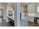 Bright white kitchen features stainless steel appliances and modern finishes with a long marble countertop at 1459 Bennett Creek Ovlk, Suwanee, GA 30024