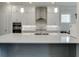 Modern kitchen with stainless steel appliances, white cabinets, quartz countertop and island sink at 1459 Bennett Creek Ovlk, Suwanee, GA 30024