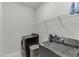 Functional laundry room with modern appliances and wire shelving, making laundry tasks efficient and organized at 1459 Bennett Creek Ovlk, Suwanee, GA 30024